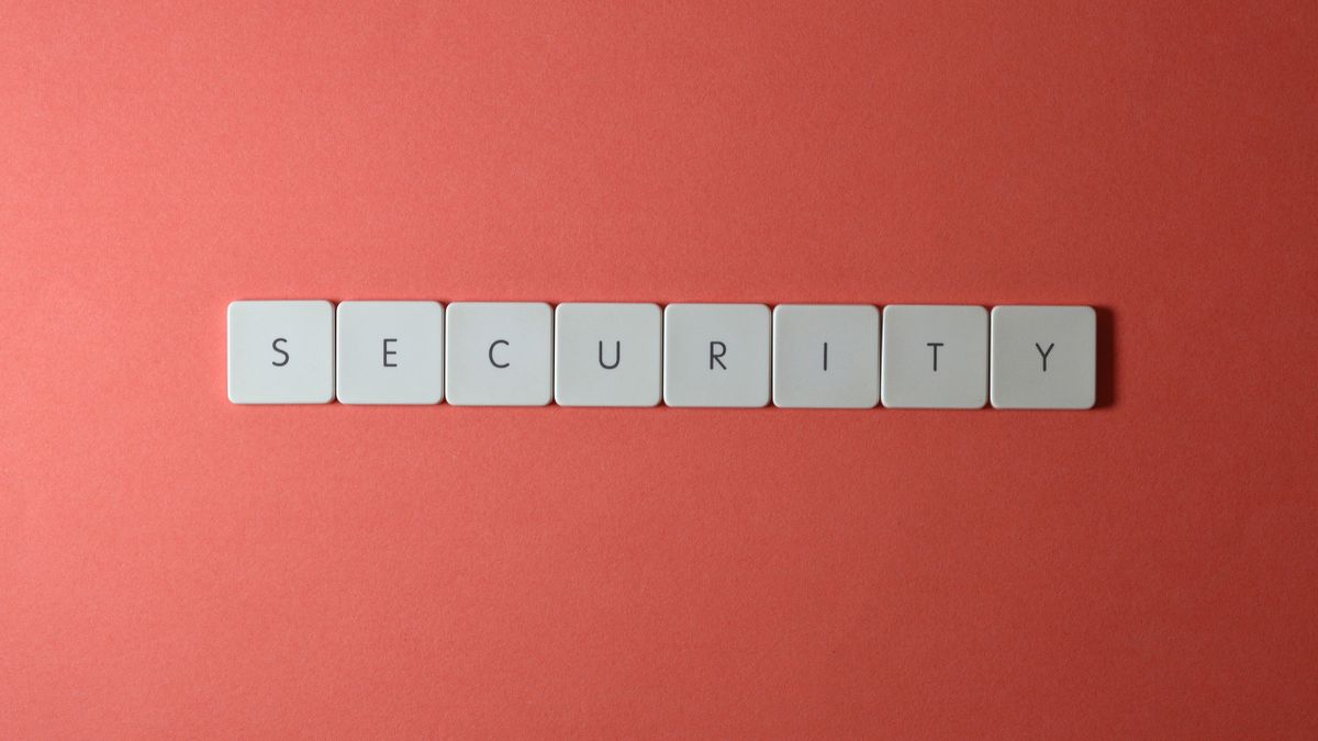 Keyboard keys spelling security on a red surface