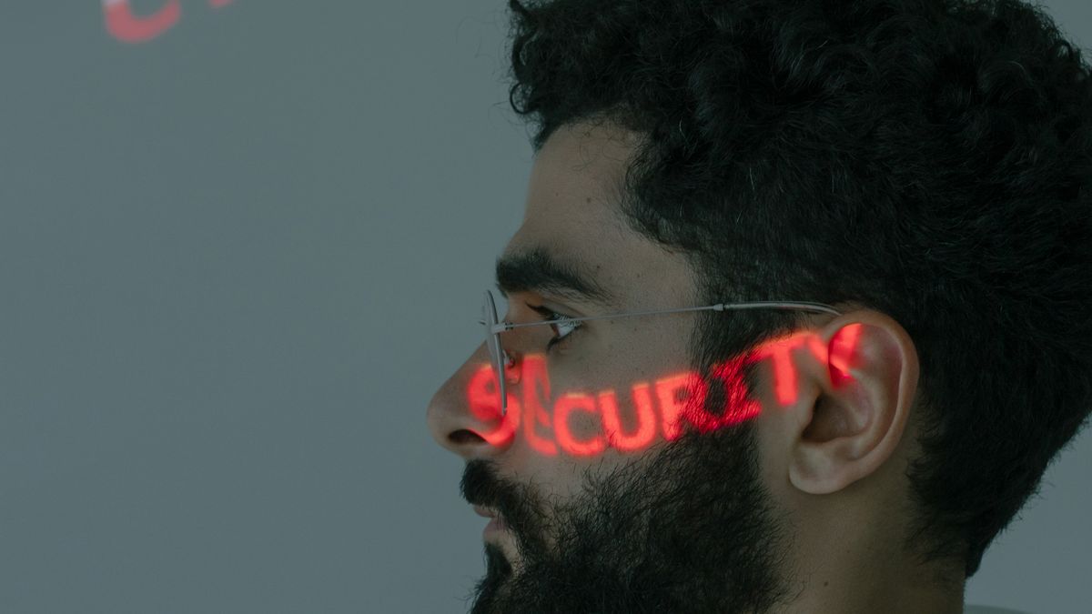 Man with cyber security text projected on his face